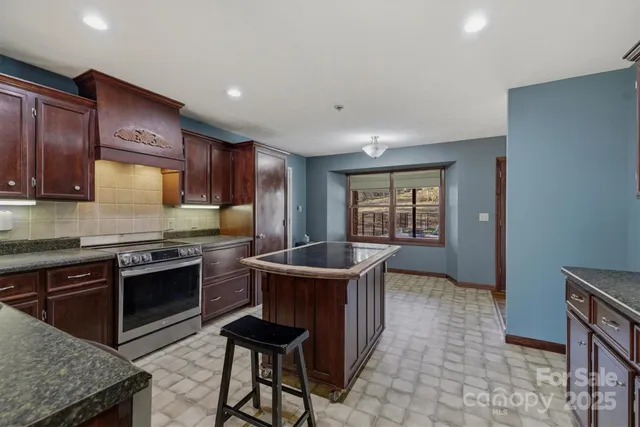 a kitchen with a stove a sink a microwave and a dining table