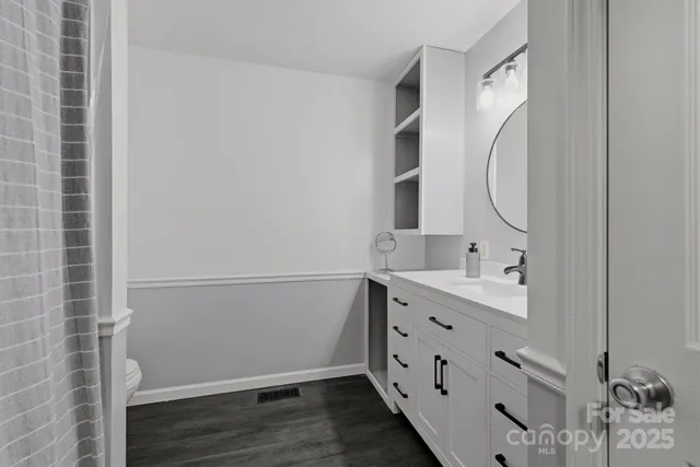 a bathroom with a double vanity sink and mirror