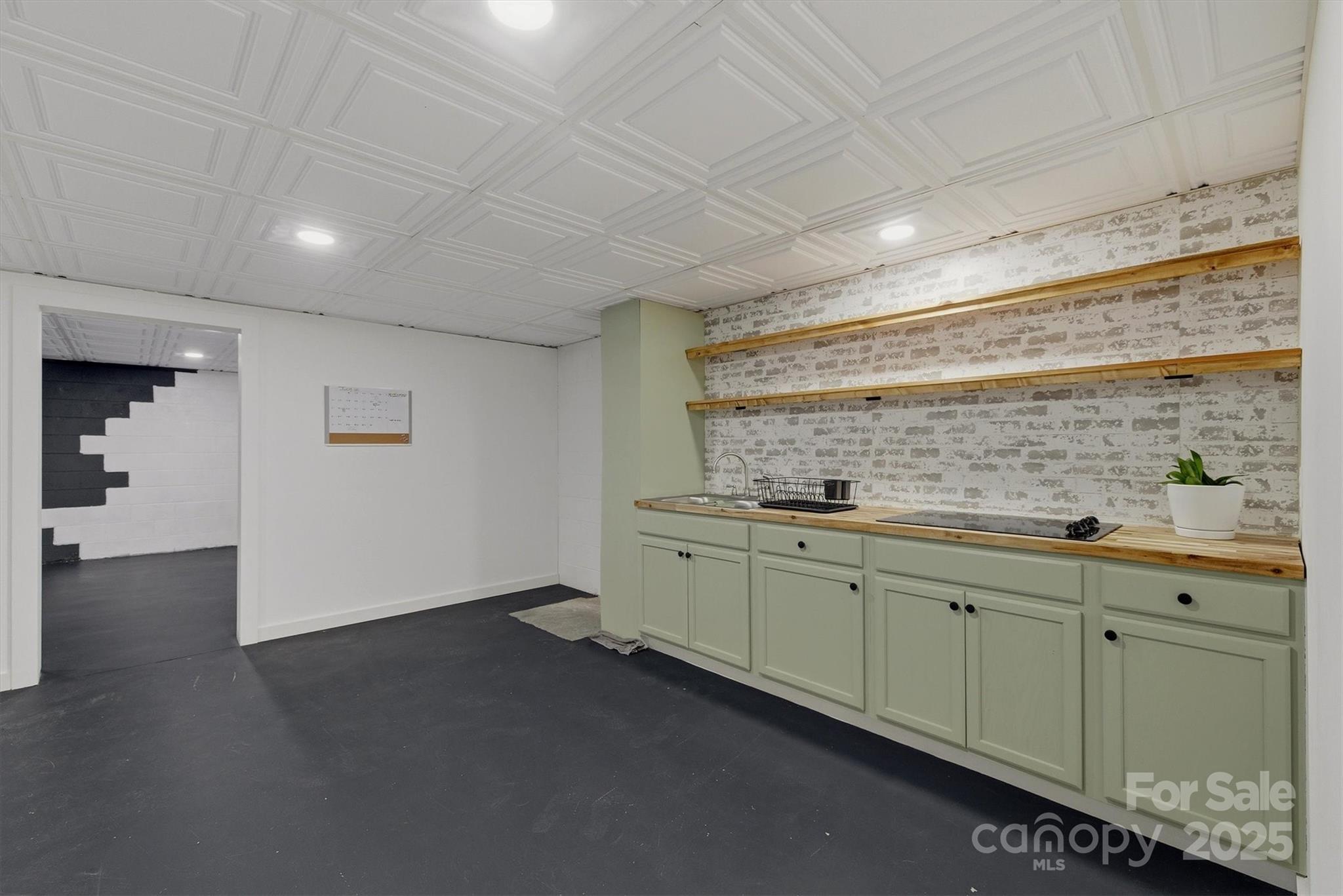 5341 Reese Store Avenue Morganton, NC 28655 - Photo 37 of 45 a room with granite countertop lots of wooden cabinets and sink