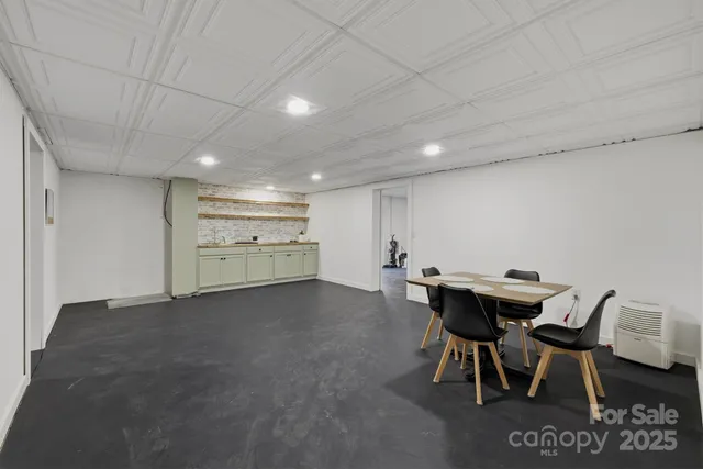 a view of a dining room with furniture and a kitchen