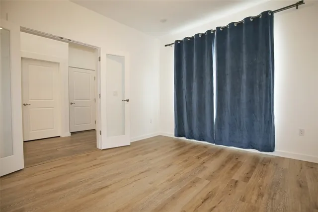 a view of a kitchen with wooden floor and electronic appliances