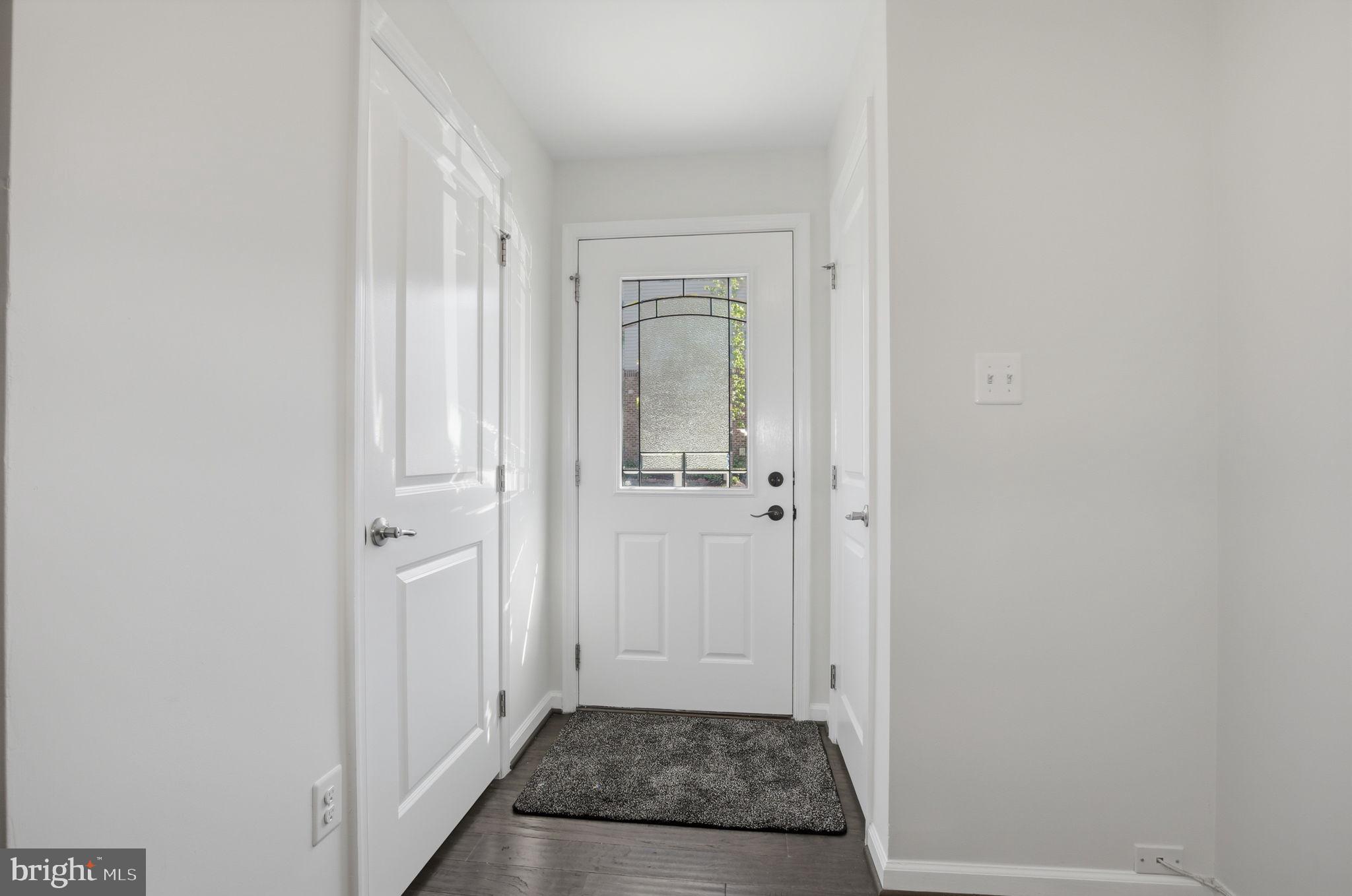 2784 Fredericksburg Road Hanover, MD 21076 - Photo 6 of 60 a view of a hallway with wooden floor and a bathroom