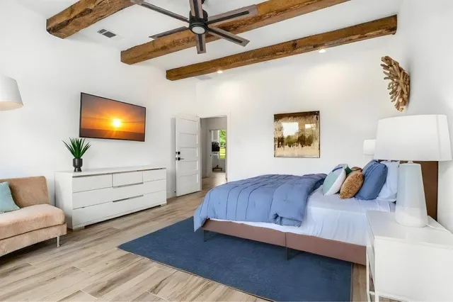 a bedroom with bed and wooden floor