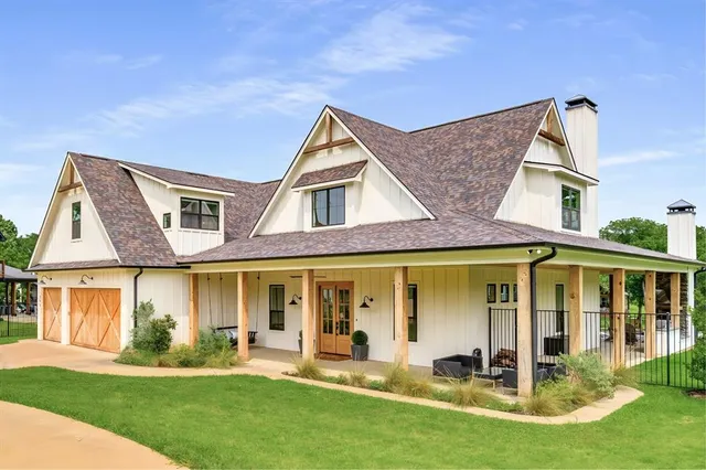 an aerial view of a house with swimming pool lawn chairs and a yard