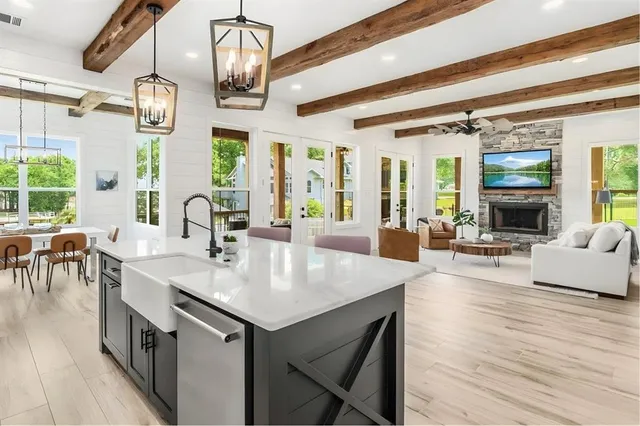 a dining room with furniture a chandelier and wooden floor