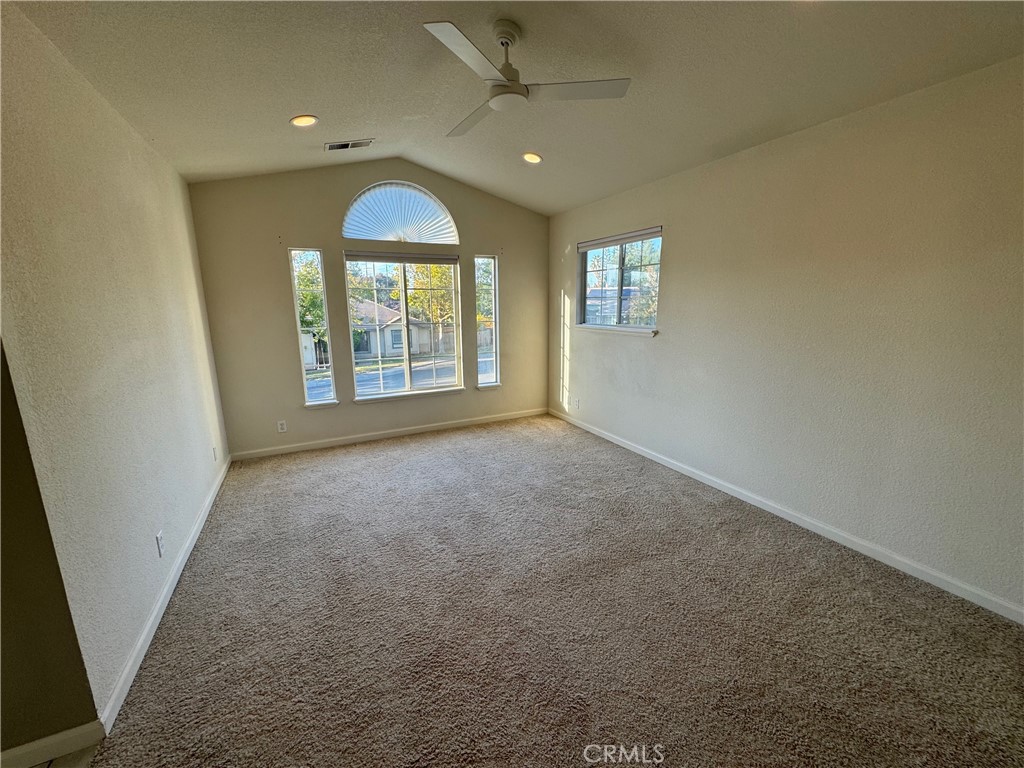 2673 Lakewest Drive Chico, CA 95928 - Photo 11 of 26 an empty room with large windows and chandelier