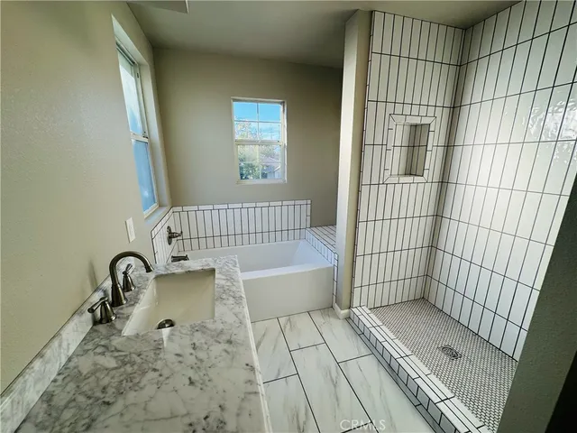a bathroom with a bathtub and shower