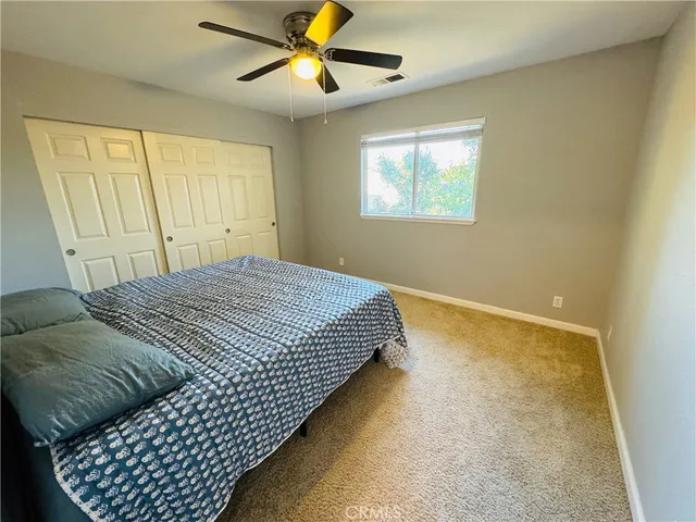 a bedroom with bed and window