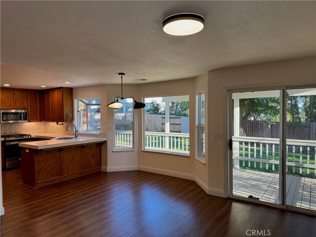 2673 Lakewest Drive Chico, CA 95928 - Photo 5 of 26 a kitchen with stainless steel appliances granite countertop a stove a sink and a large window