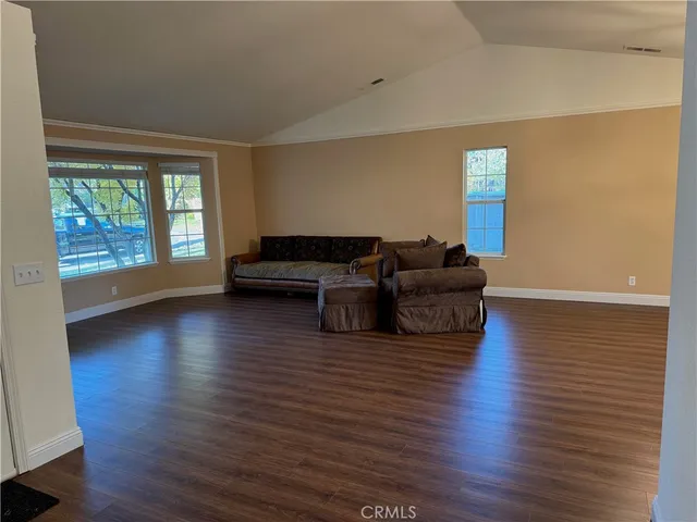 a living room with furniture window and wooden floor