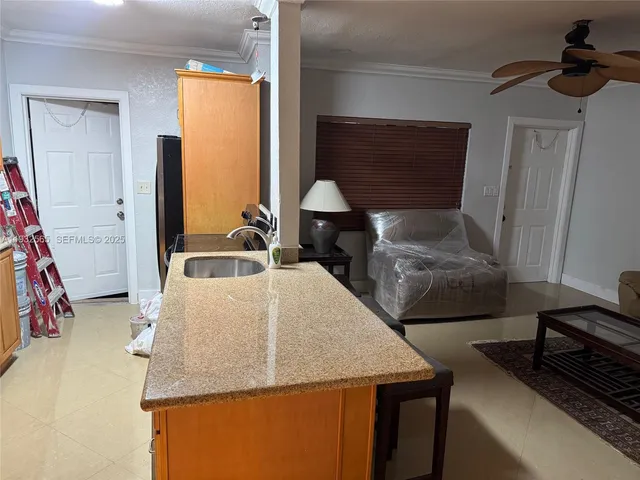 a kitchen with stainless steel appliances granite countertop a sink stove and microwave