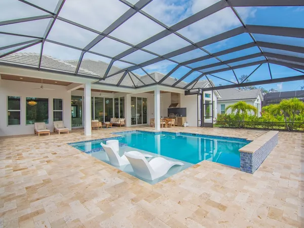 a view of a backyard with a swimming pool
