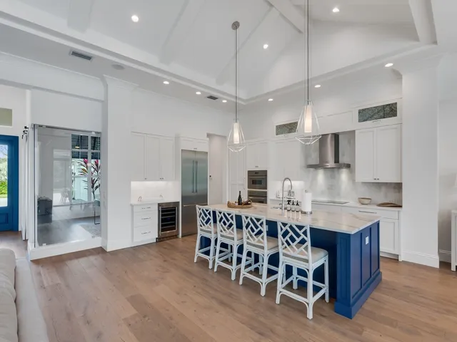 a large kitchen with a table and chairs in it
