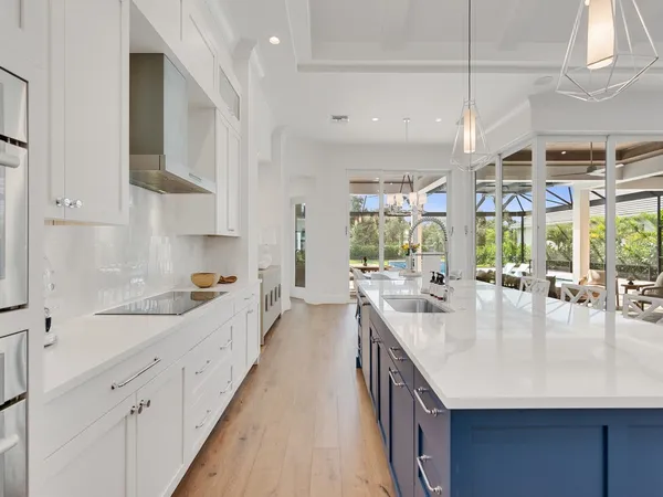 a kitchen with sink stove and cabinets