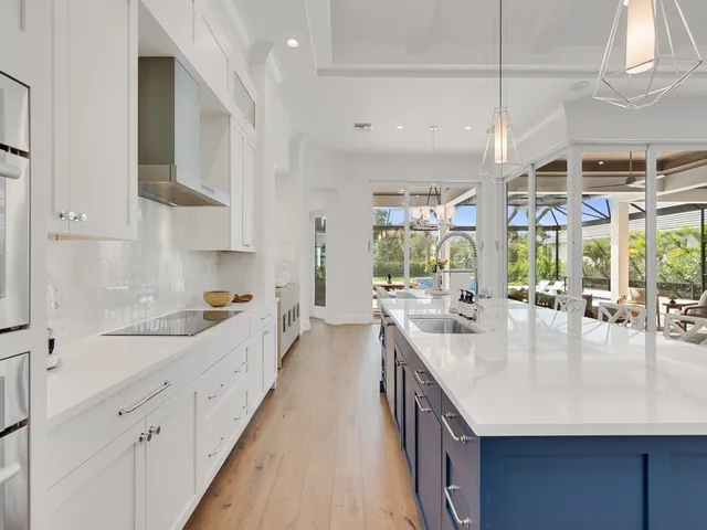 a kitchen with sink stove and cabinets