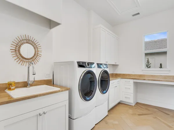 a utility room with sink dryer and washer