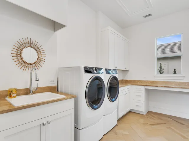a utility room with sink dryer and washer