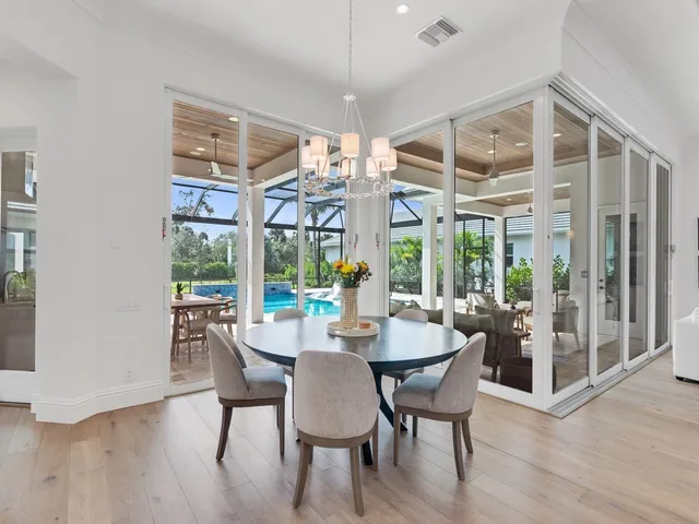 a view of a dining room with furniture wooden floor and chandelier