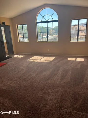 an empty room with a empty space and windows