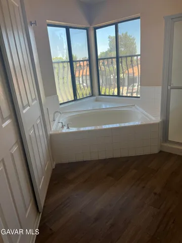 a view of bathroom with bathtub and closet