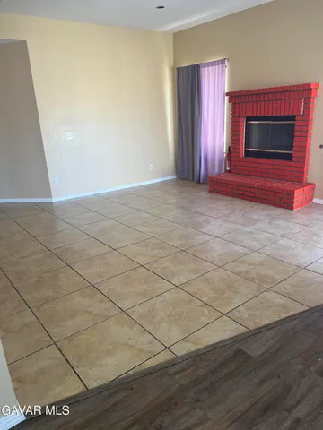 a view of an empty room with a fireplace