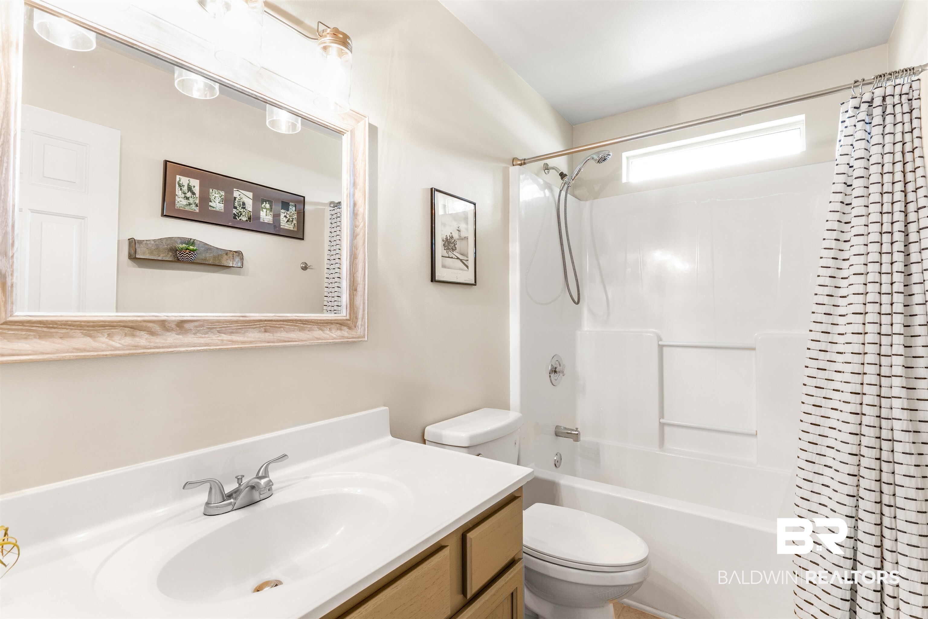 518 Ariel Avenue Foley, AL 36535 - Photo 30 of 47 Full bathroom featuring vanity, toilet, and shower / tub combo with curtain