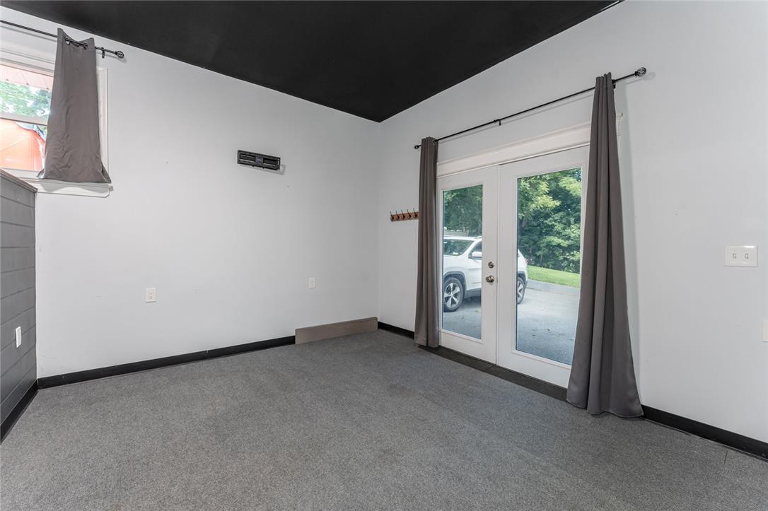 402 Maple Street Roseto, PA 18013 - Photo 29 of 39 Double glass doors open to the outdoors from this versatile space with plush carpeting.