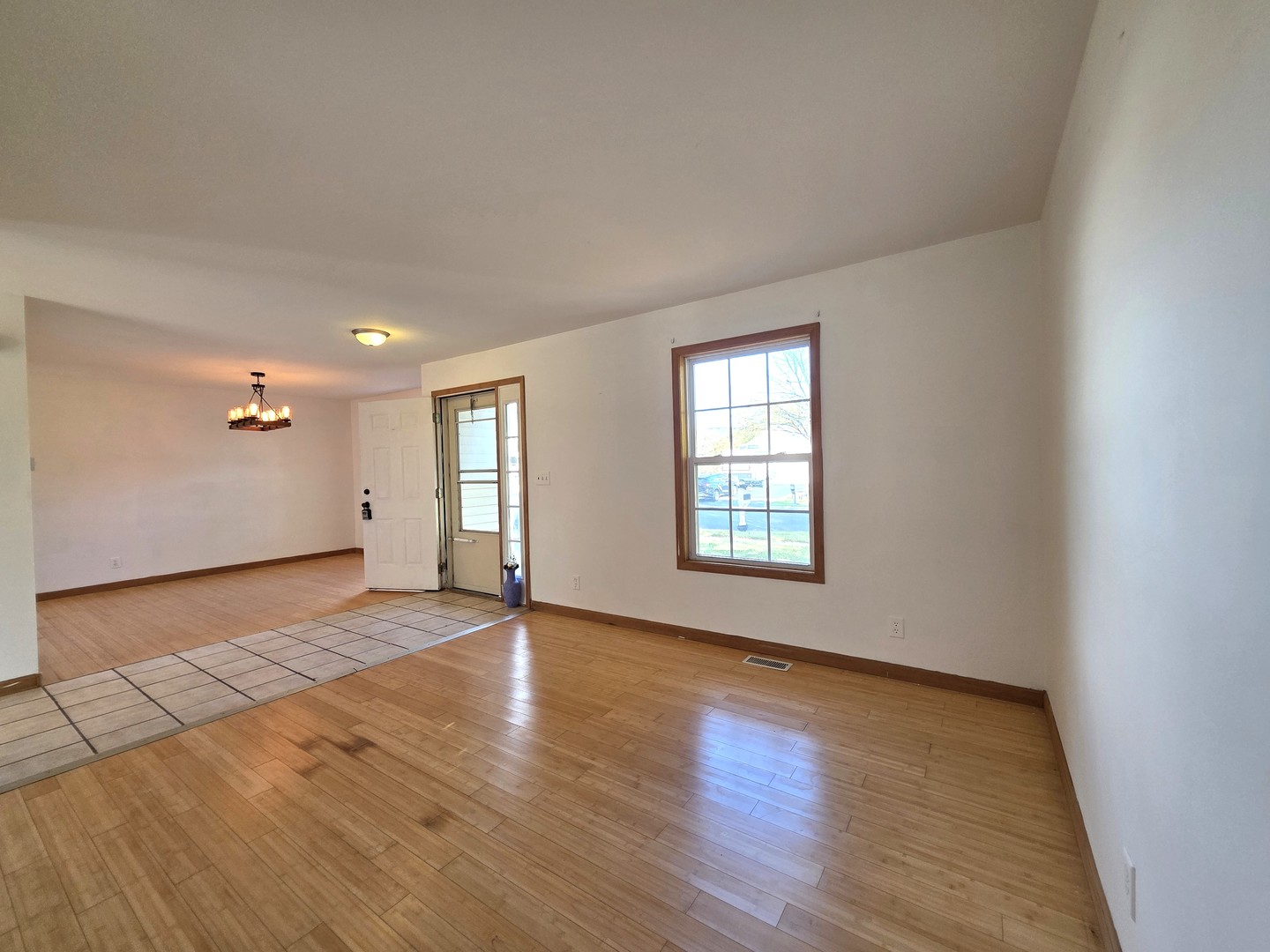 2513 Ridgefield Drive Belvidere, IL 61008 - Photo 3 of 35 an empty room with wooden floor and windows