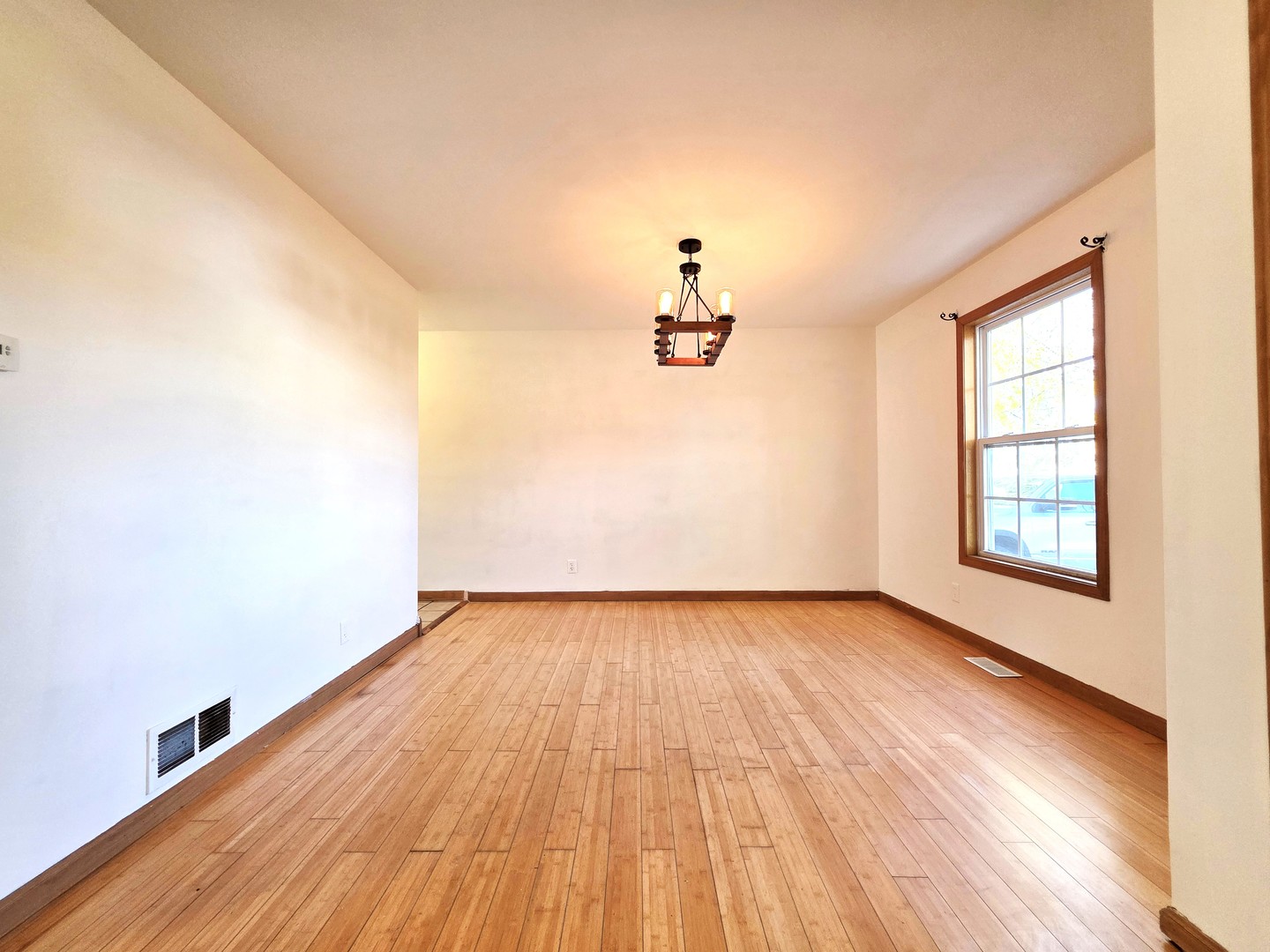 2513 Ridgefield Drive Belvidere, IL 61008 - Photo 5 of 35 wooden floor in an empty room with a window