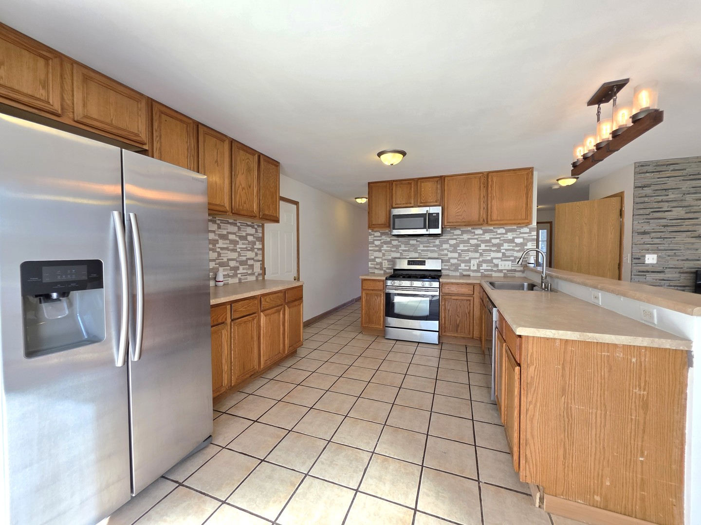 2513 Ridgefield Drive Belvidere, IL 61008 - Photo 10 of 35 a kitchen with stainless steel appliances a refrigerator and a stove