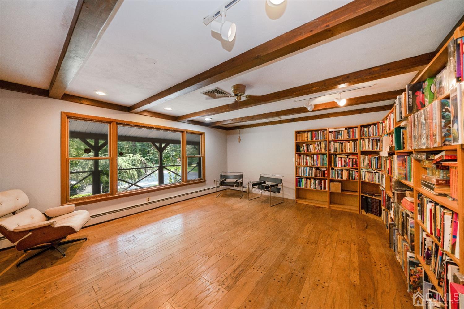 109 Fresh Ponds Road Monroe Township, NJ 08831 - Photo 3 of 83 a big room with wooden floor and furniture