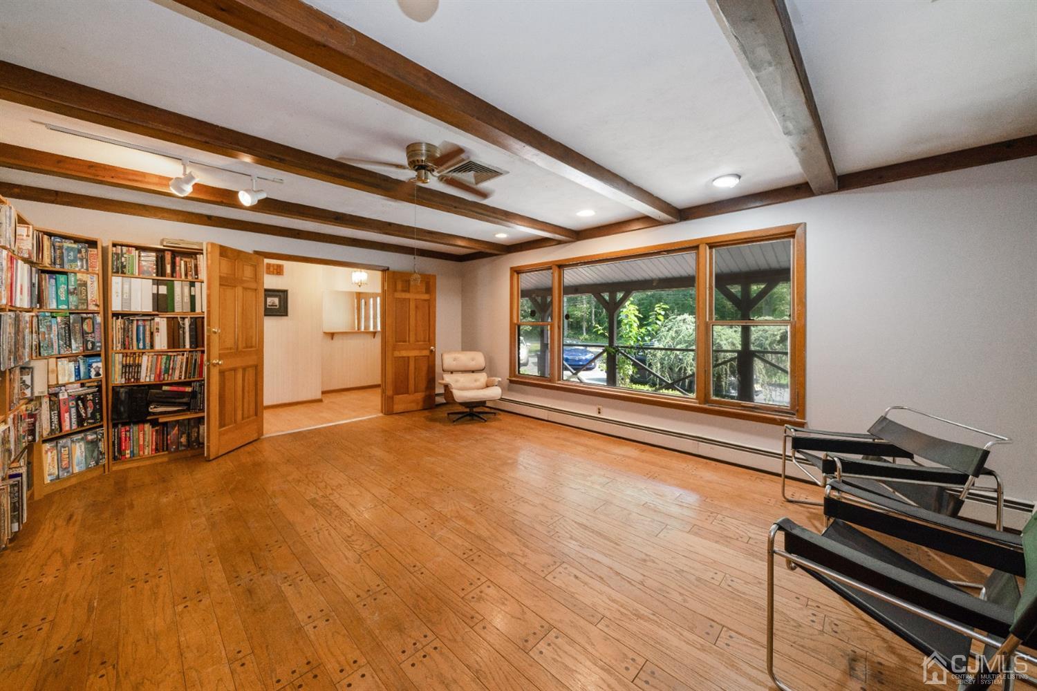 109 Fresh Ponds Road Monroe Township, NJ 08831 - Photo 4 of 83 a view of empty room with wooden floor and fan