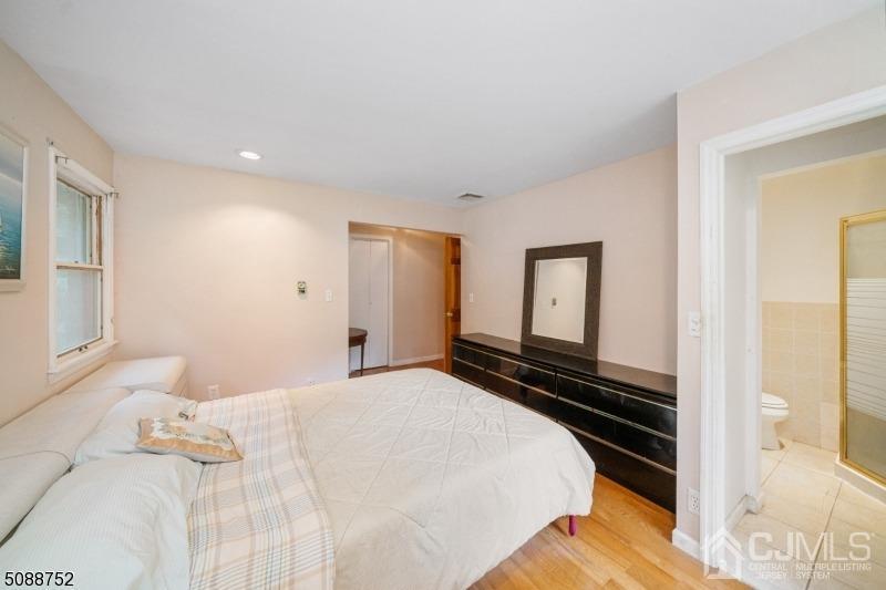109 Fresh Ponds Road Monroe Township, NJ 08831 - Photo 43 of 83 a bedroom with a bed and wooden floor