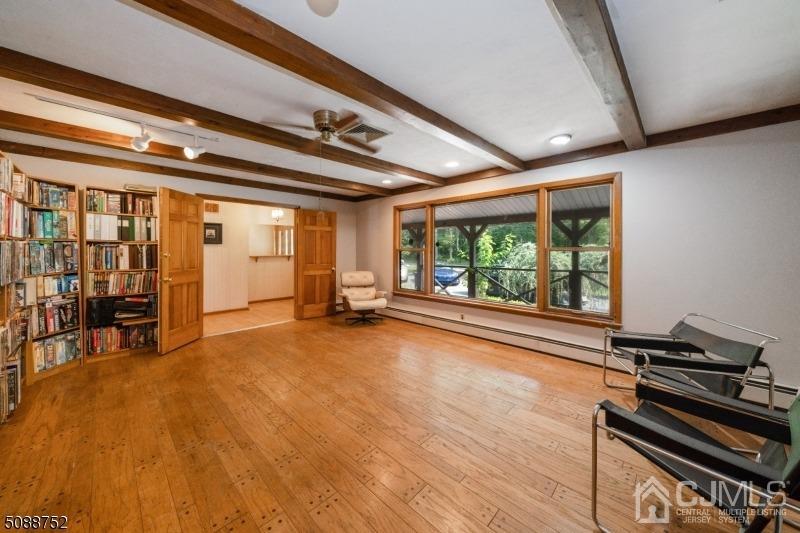 109 Fresh Ponds Road Monroe Township, NJ 08831 - Photo 50 of 83 a view of an empty room with wooden floor and windows