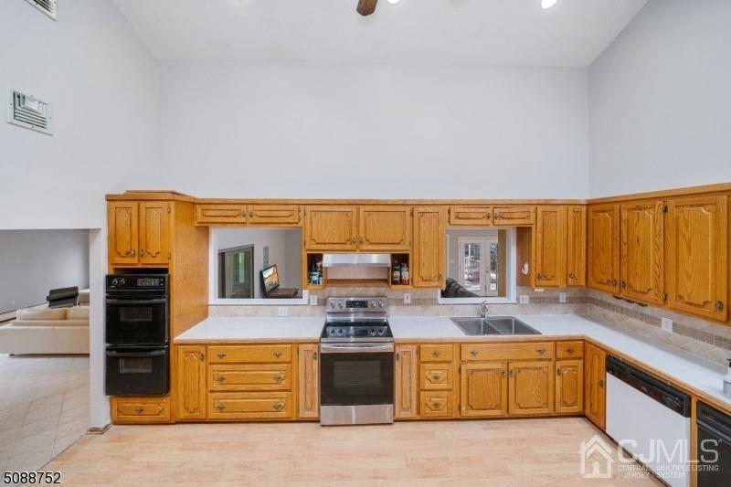 109 Fresh Ponds Road Monroe Township, NJ 08831 - Photo 55 of 83 a kitchen with stainless steel appliances granite countertop a stove a sink and a microwave