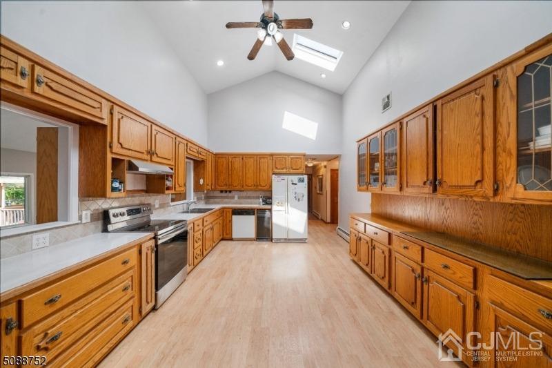 109 Fresh Ponds Road Monroe Township, NJ 08831 - Photo 56 of 83 a large kitchen with stainless steel appliances granite countertop a lot of counter space and wooden floors