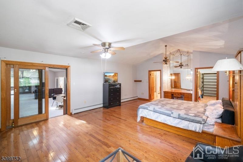 109 Fresh Ponds Road Monroe Township, NJ 08831 - Photo 78 of 83 a spacious bedroom with a large bed and a chandelier