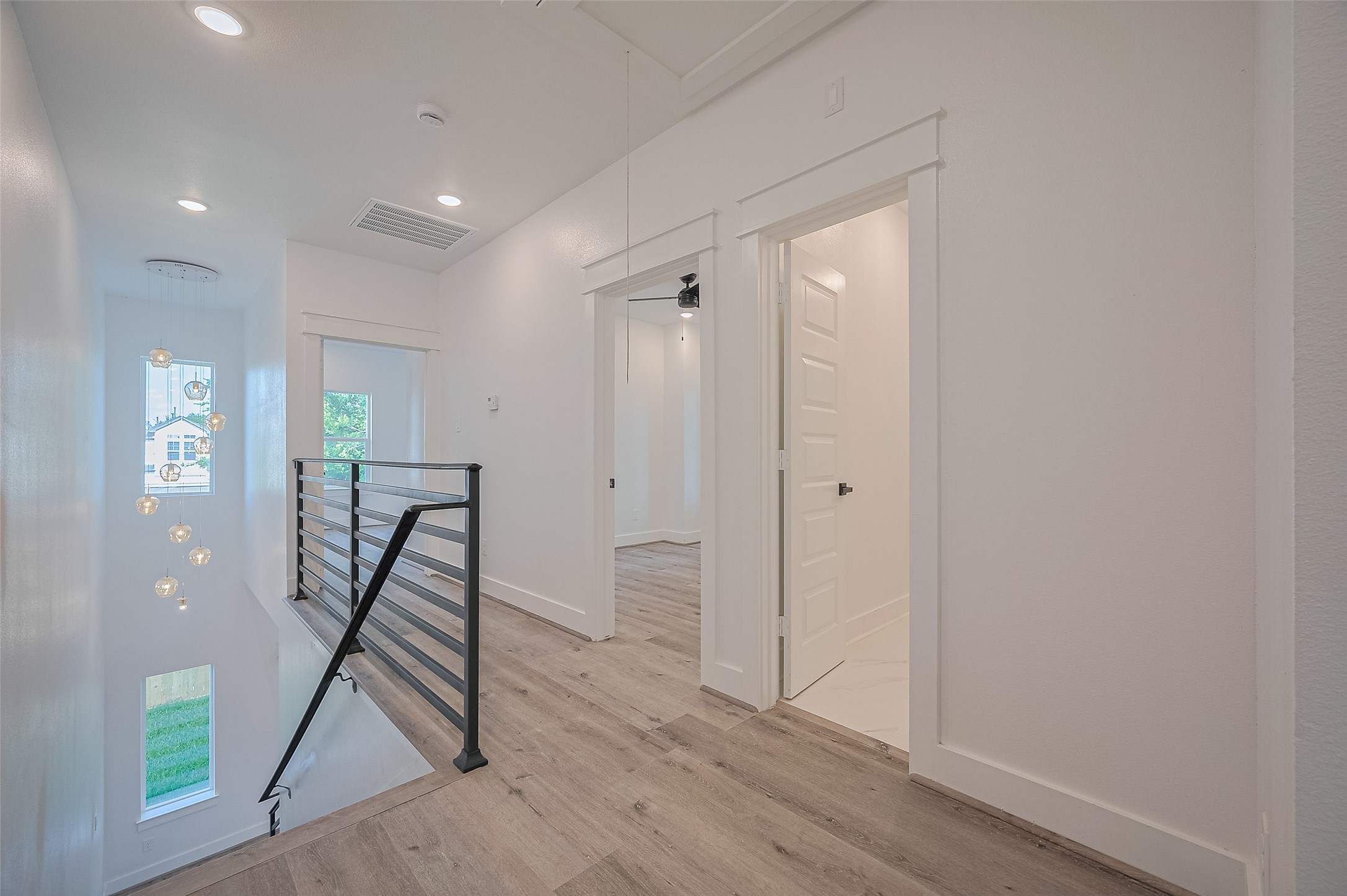 6747 Liverpool Street Houston, TX 77021 - Photo 17 of 18 The second floor boasts sleek black metal railings overlooking the main level and includes access to three generously sized bedrooms.