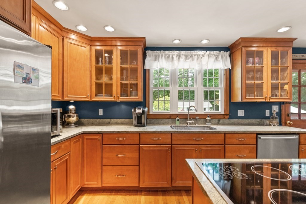 8 Candlewood Road Lynnfield, MA 01940 - Photo 18 of 41 a kitchen with stainless steel appliances granite countertop a sink and a refrigerator