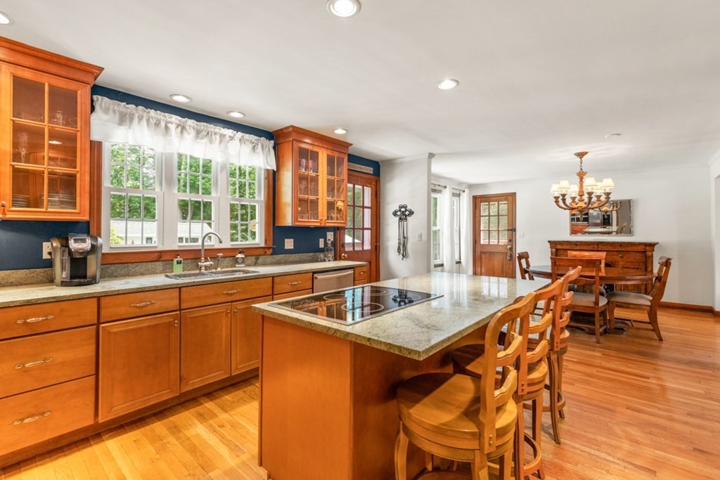 8 Candlewood Road Lynnfield, MA 01940 - Photo 19 of 41 a kitchen with stainless steel appliances granite countertop a sink and a wooden cabinets