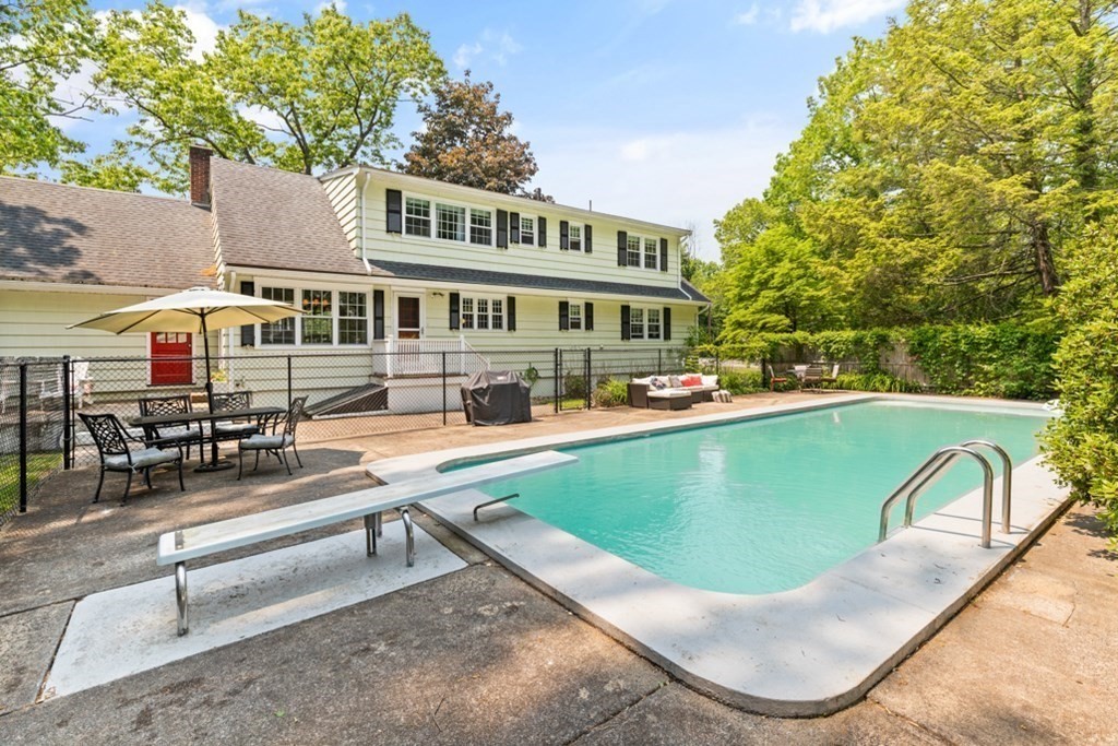 8 Candlewood Road Lynnfield, MA 01940 - Photo 36 of 41 a view of a swimming pool with a lounge chairs