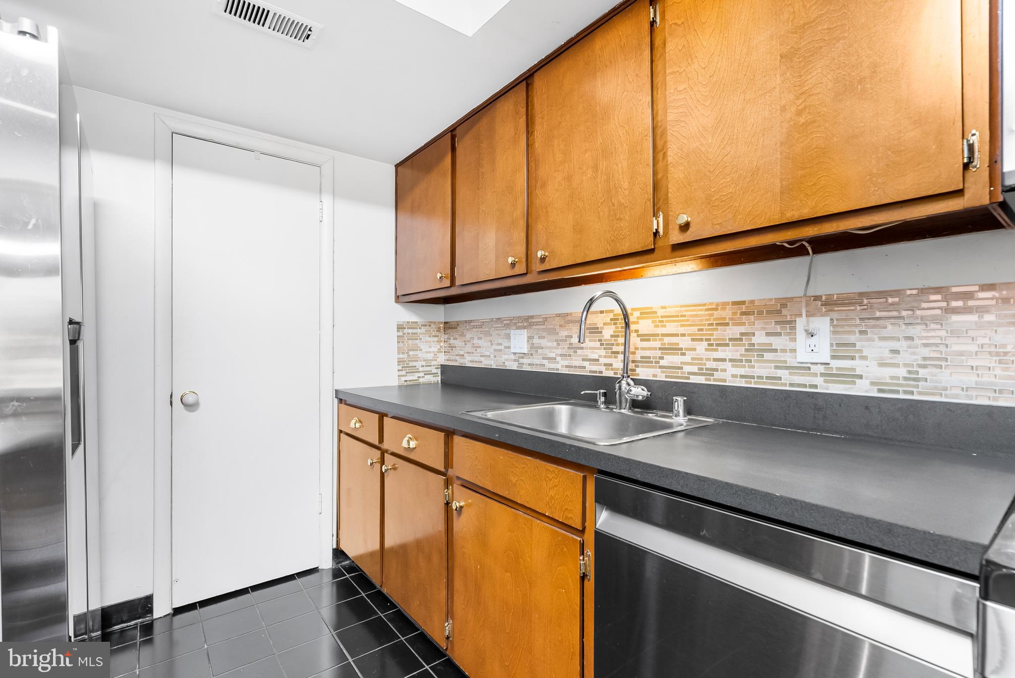 110 Cross Keys Road, Unit F Baltimore, MD 21210 - Photo 30 of 47 a kitchen with stainless steel appliances granite countertop a sink and a window