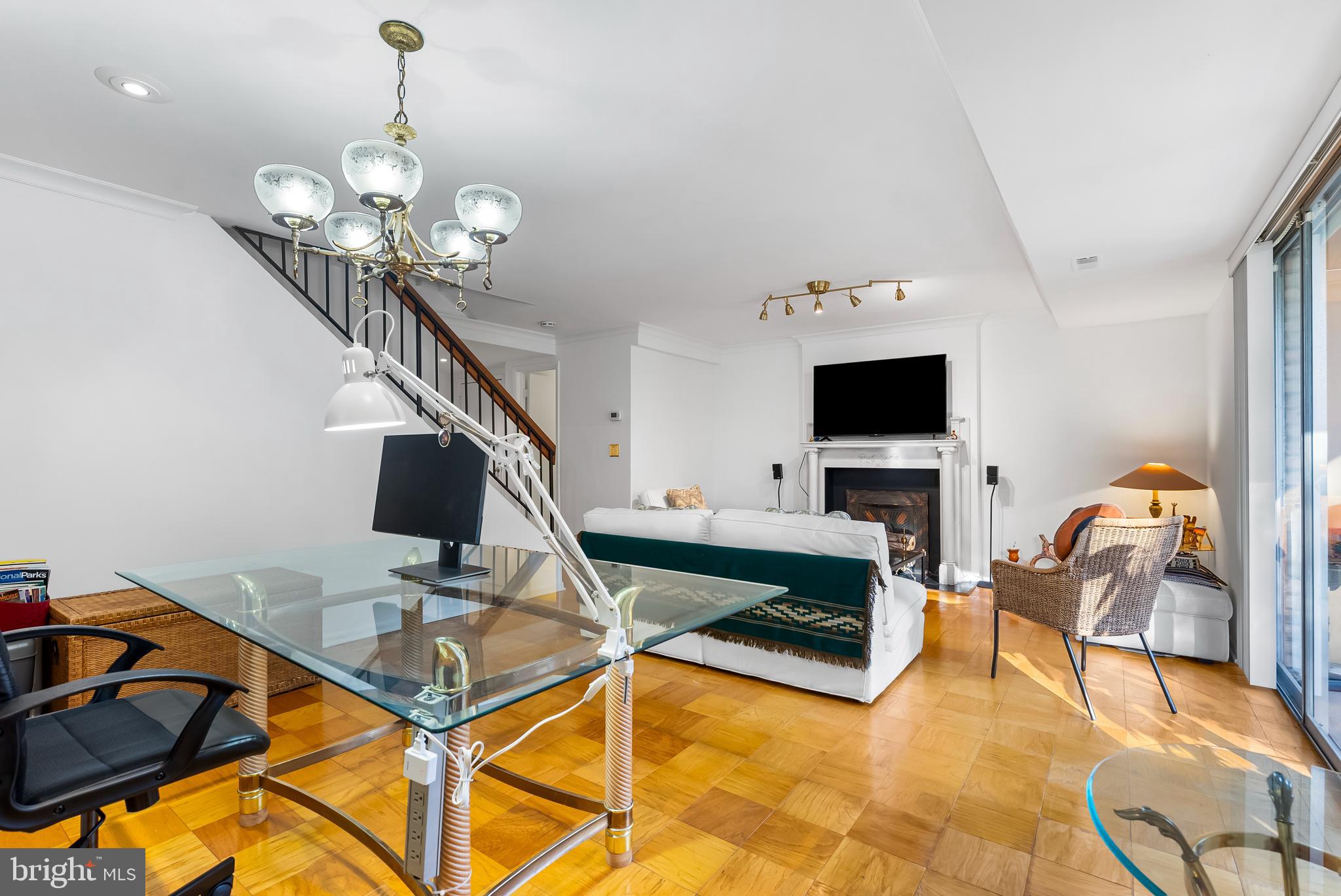 110 Cross Keys Road, Unit F Baltimore, MD 21210 - Photo 3 of 47 a living room with furniture a flat screen tv and a chandelier