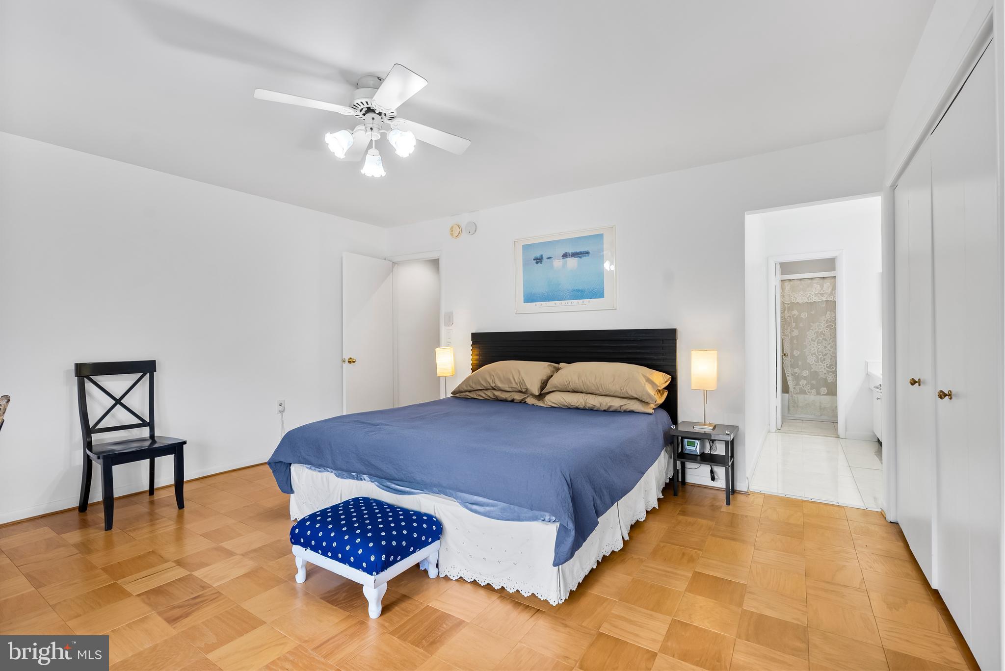 110 Cross Keys Road, Unit F Baltimore, MD 21210 - Photo 41 of 47 a spacious bedroom with a bed and a table in it