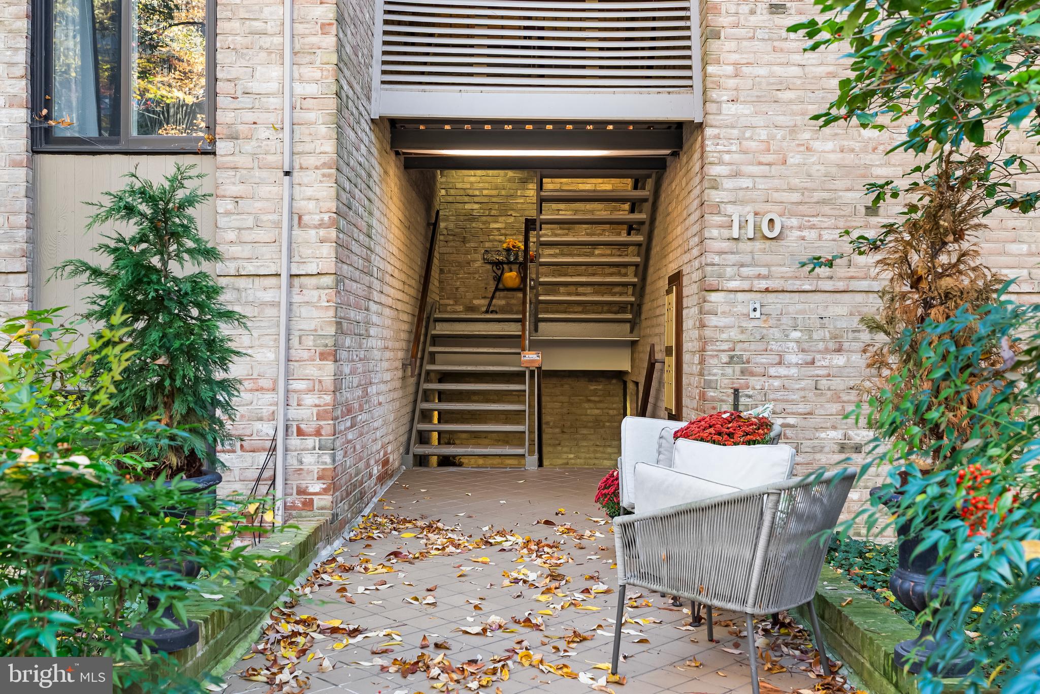 110 Cross Keys Road, Unit F Baltimore, MD 21210 - Photo 45 of 47 a balcony with table and chairs and potted plants