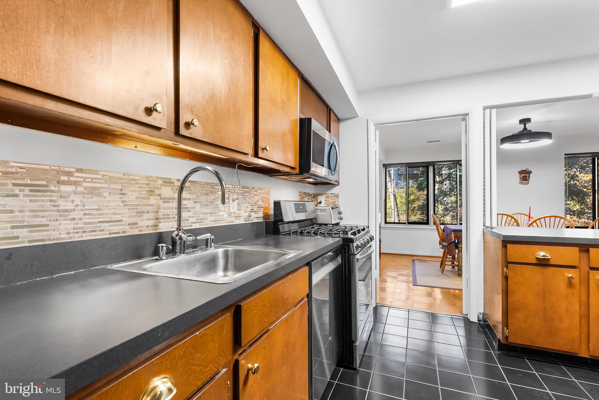 110 Cross Keys Road, Unit F Baltimore, MD 21210 - Photo 46 of 47 a kitchen with stainless steel appliances a sink stove and cabinets