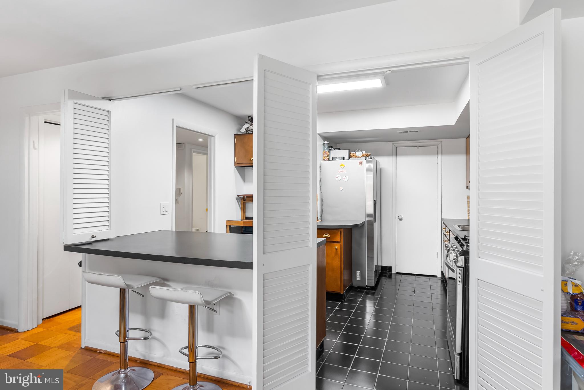 110 Cross Keys Road, Unit F Baltimore, MD 21210 - Photo 5 of 47 a kitchen with a table and chairs in it