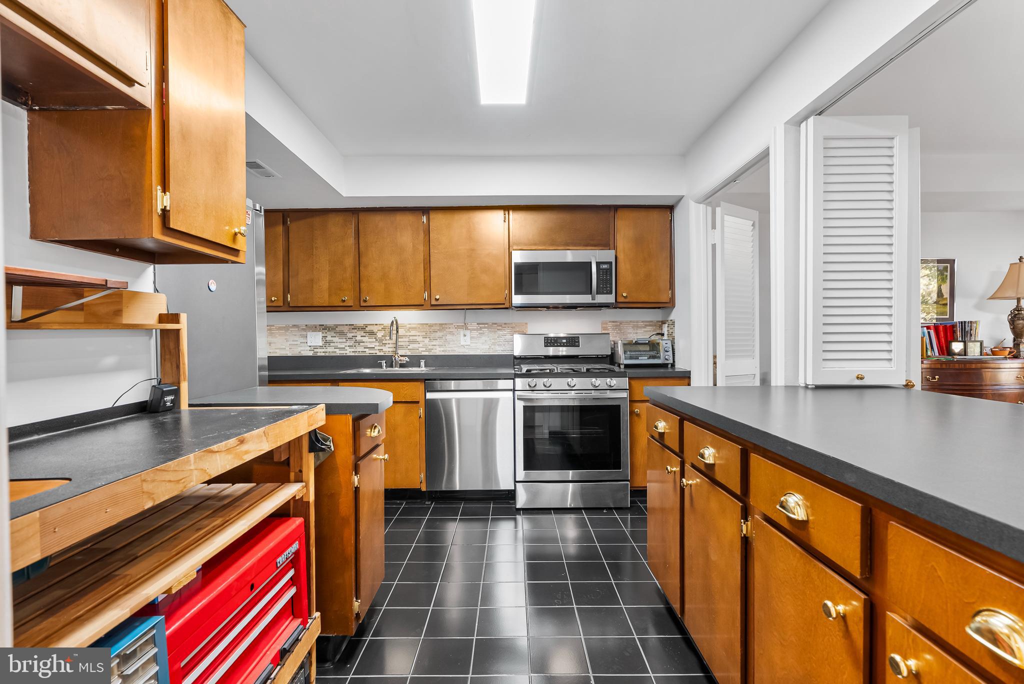 110 Cross Keys Road, Unit F Baltimore, MD 21210 - Photo 6 of 47 a kitchen with stainless steel appliances a stove a sink and a microwave