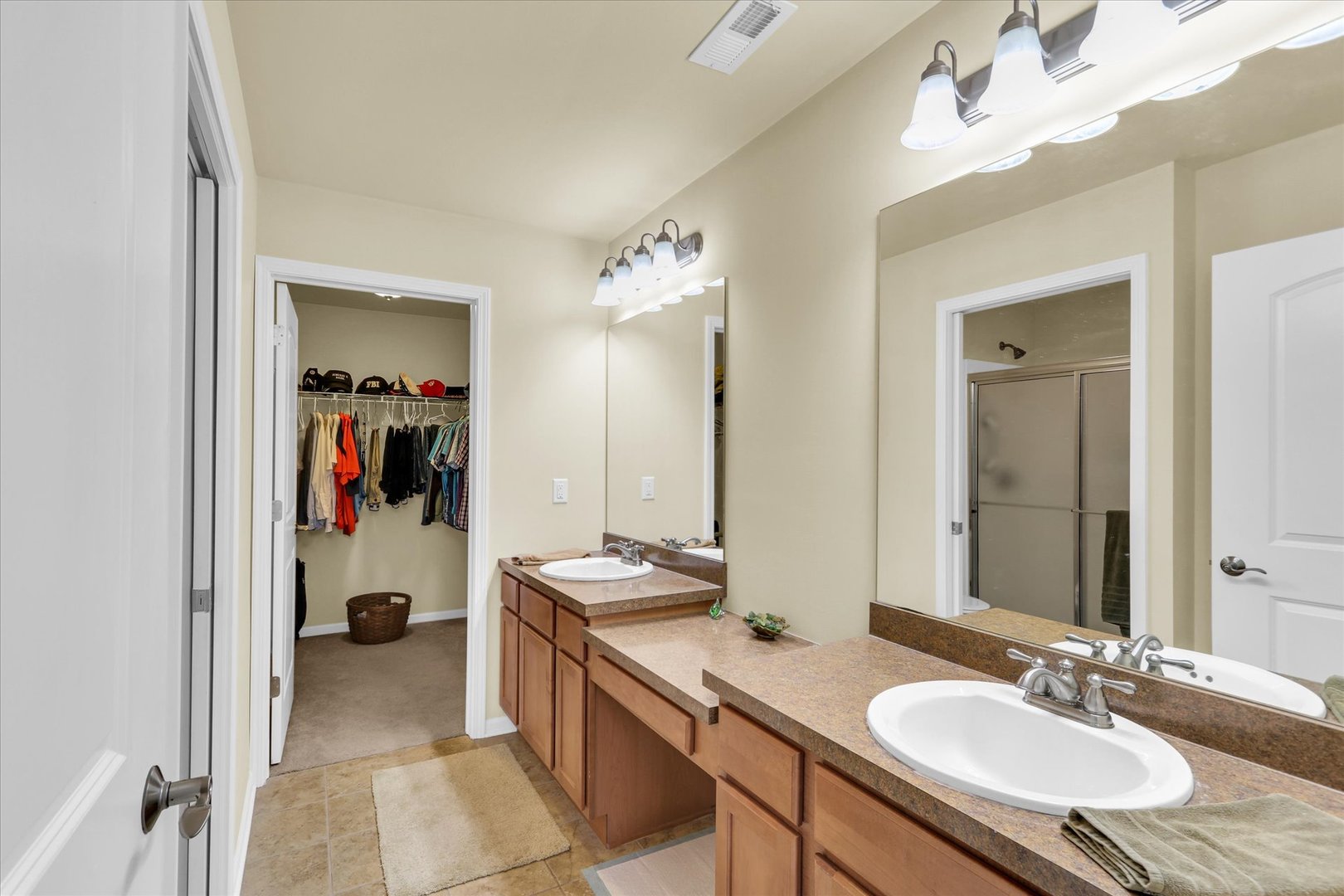 2730 Madelynn Drive Champaign, IL 61822 - Photo 10 of 35 a bathroom with a sink double vanity and a mirror