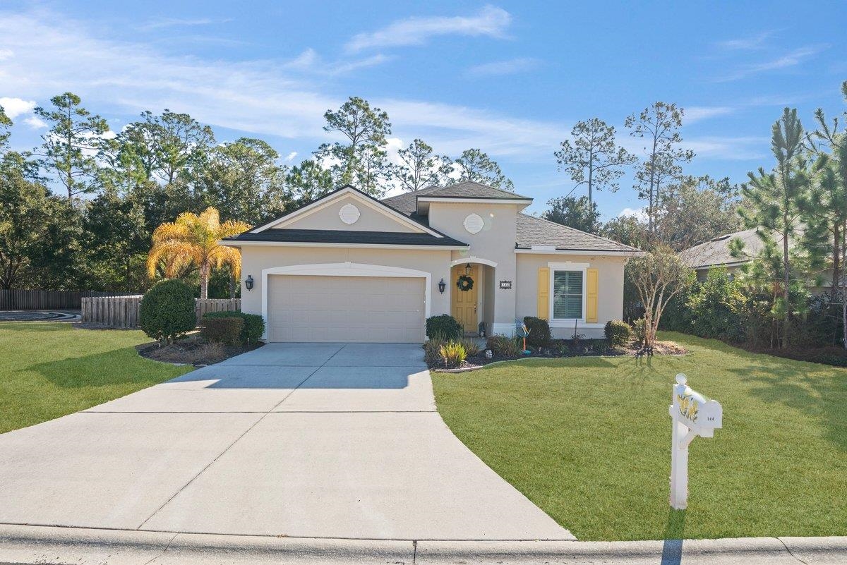 144 Litke Lane St. Augustine, FL 32086 - Photo 1 of 45 a front view of a house with garden